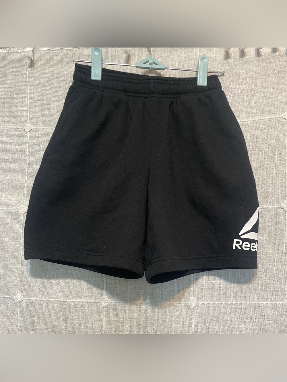 Boys black Reebok sweat shorts.
